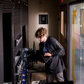 Faculty pointing at a student's computer screen.