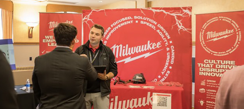 Student speaker to a recruiter at the Milwaukee Tool both.