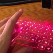 Hand typing on a virtual keyboard.