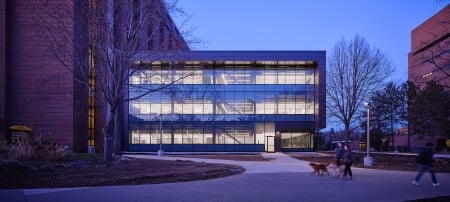 The H-STEM Complex at dawn with people walking in front.