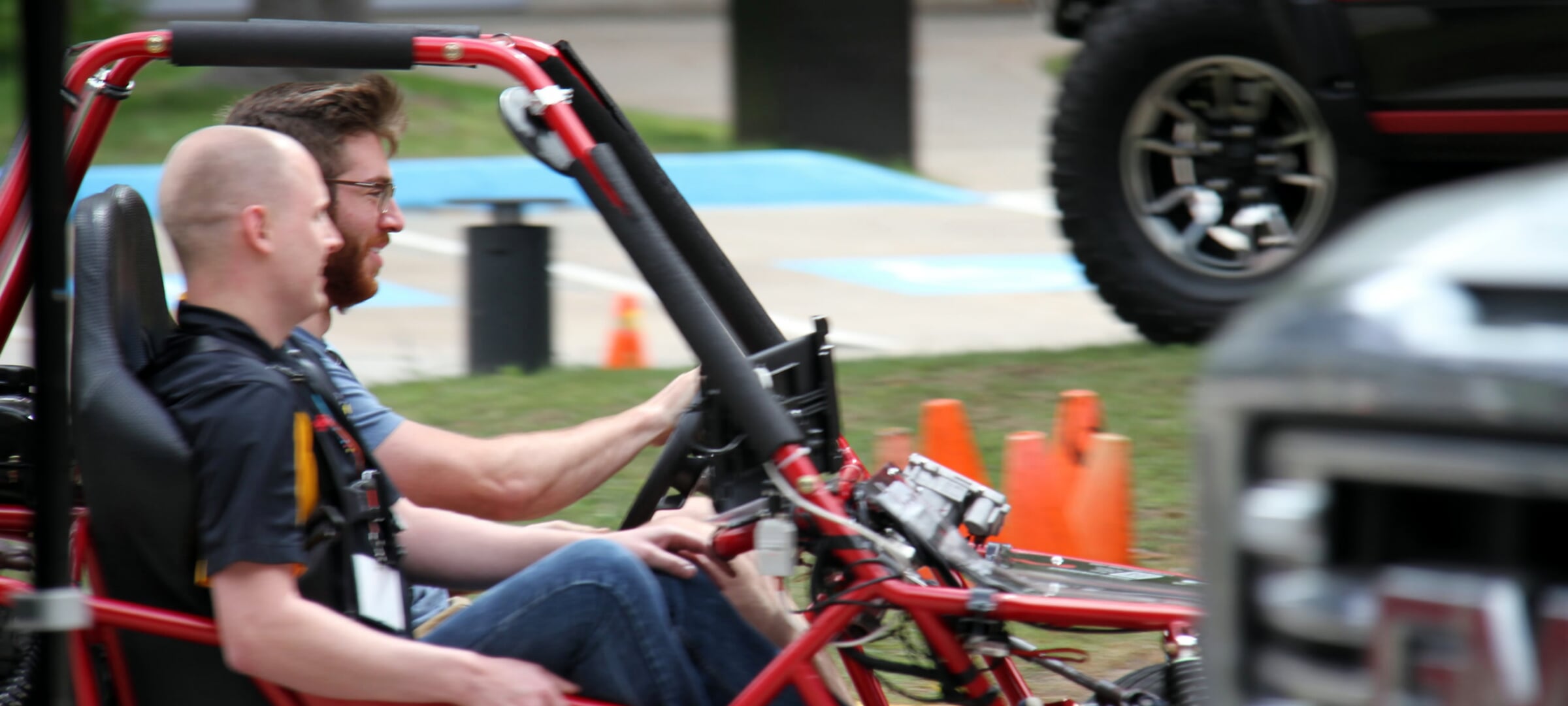 Two Automotive Systems and Controls students in a test framed car.