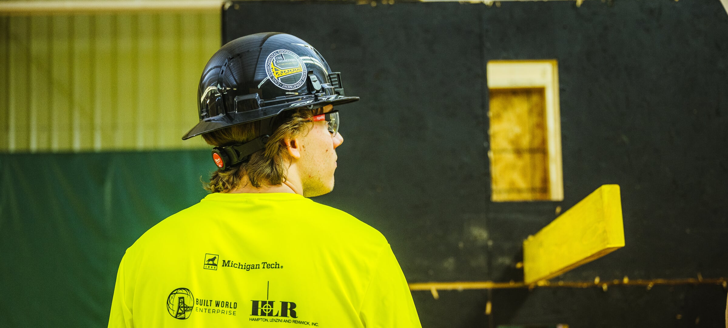 Workers in hardhats inside a building under construction