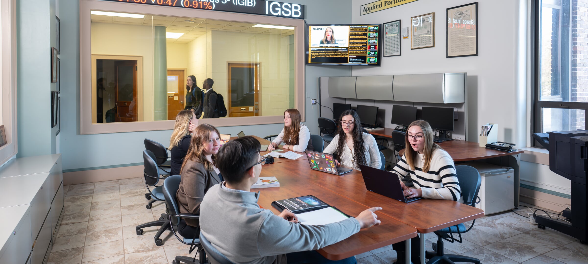 Students sitting around a conference room table.