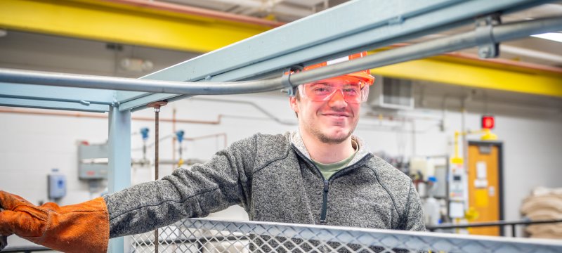 Stdent standing in front of OU Lab equipment