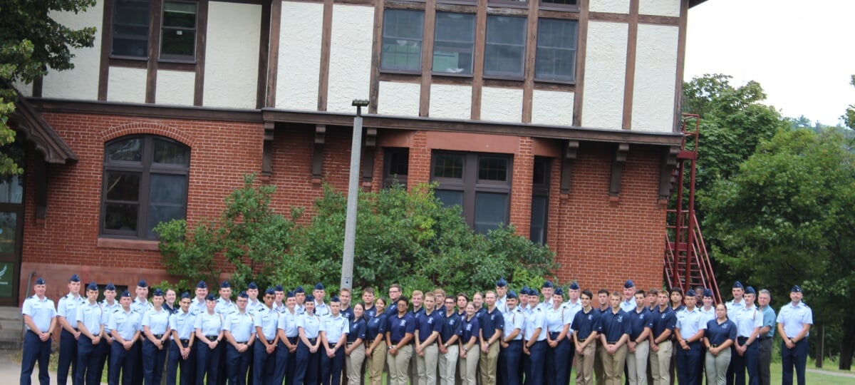Air Force ROTC cadets in Blues standing in front of the Michigan Tech ROTC building.