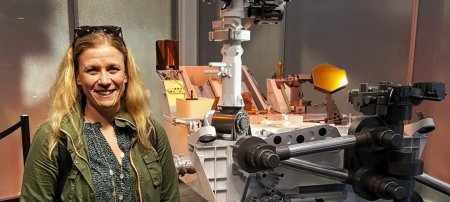 Elwell in front of Curiosity Rover Mockup (same class as Perseverance) at NASAâ€™s Jet Propulsion Laboratory