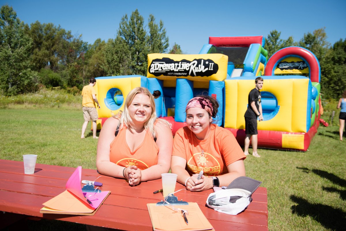 Two students sit at a table during K-Day