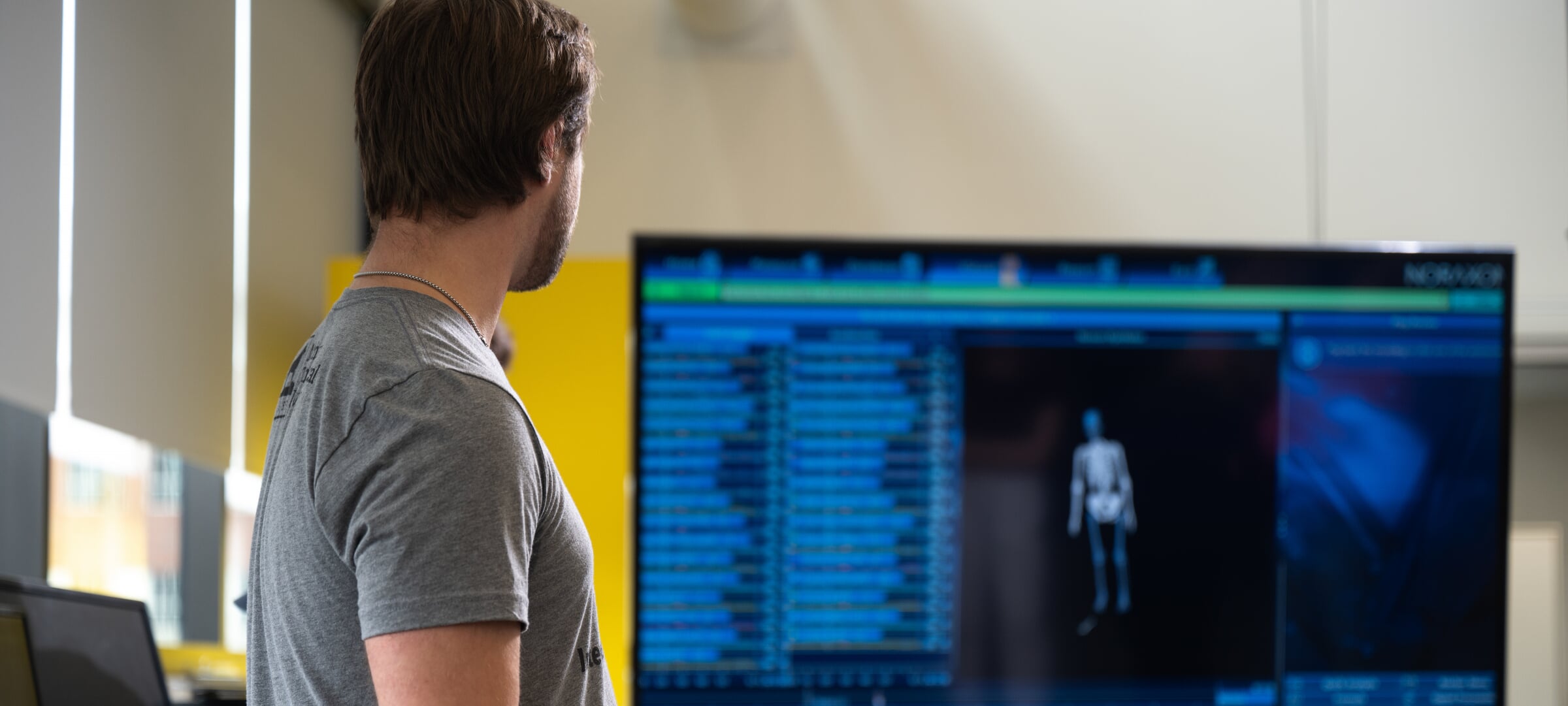 Researcher looking at biological data on a monitor.