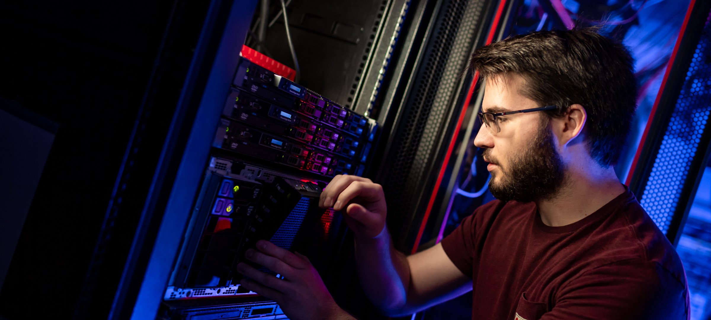 Worker in front of a server rack