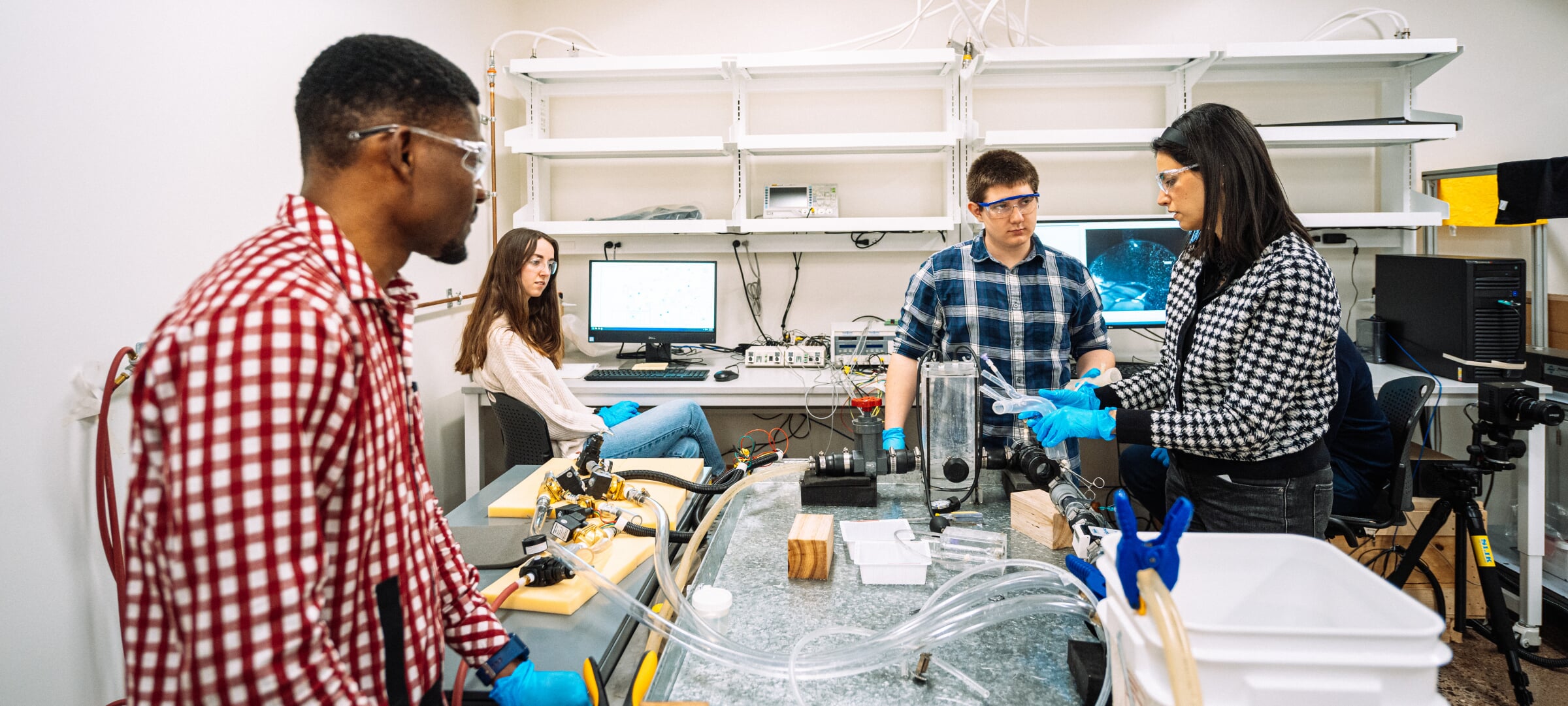 Students and faculty work in the lab.