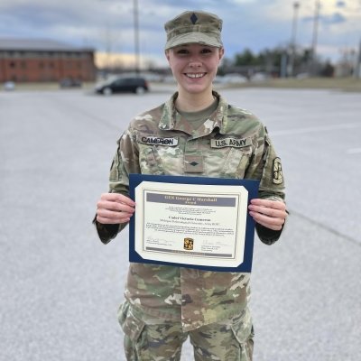 Victoria Cameron holding her honors plaque.