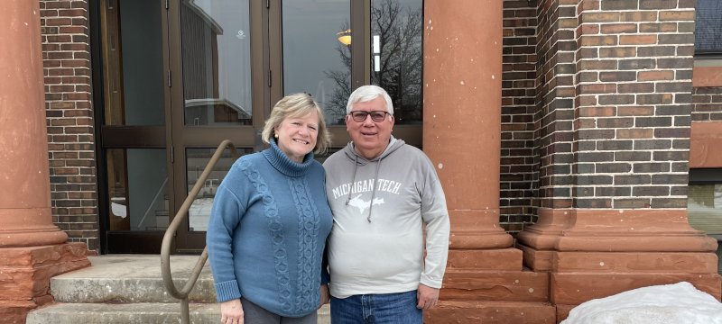 Rick Kraas and Claudette Reid in front of the Academic Office Building.