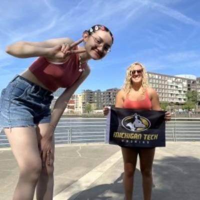 Students posing with the Michigan Tech flag in Germany's "HafenCity."