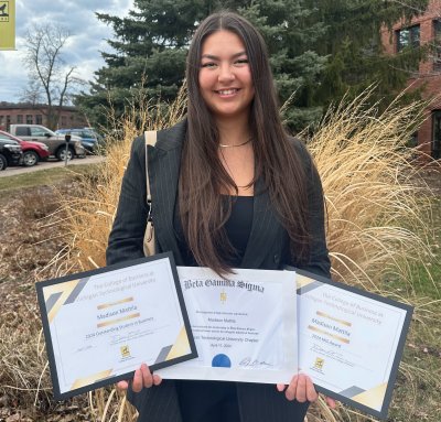 Madison Mattila holding three certificates.