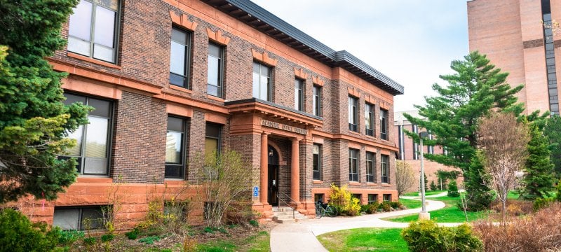 The exterior of the Academic Office Building in the summer.