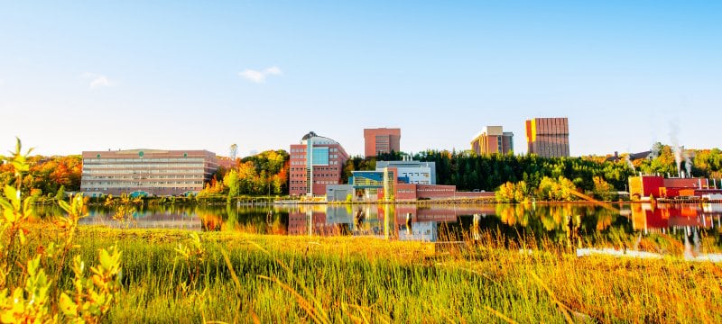 View of Michigan Tech campus from across the waterway in the fall.