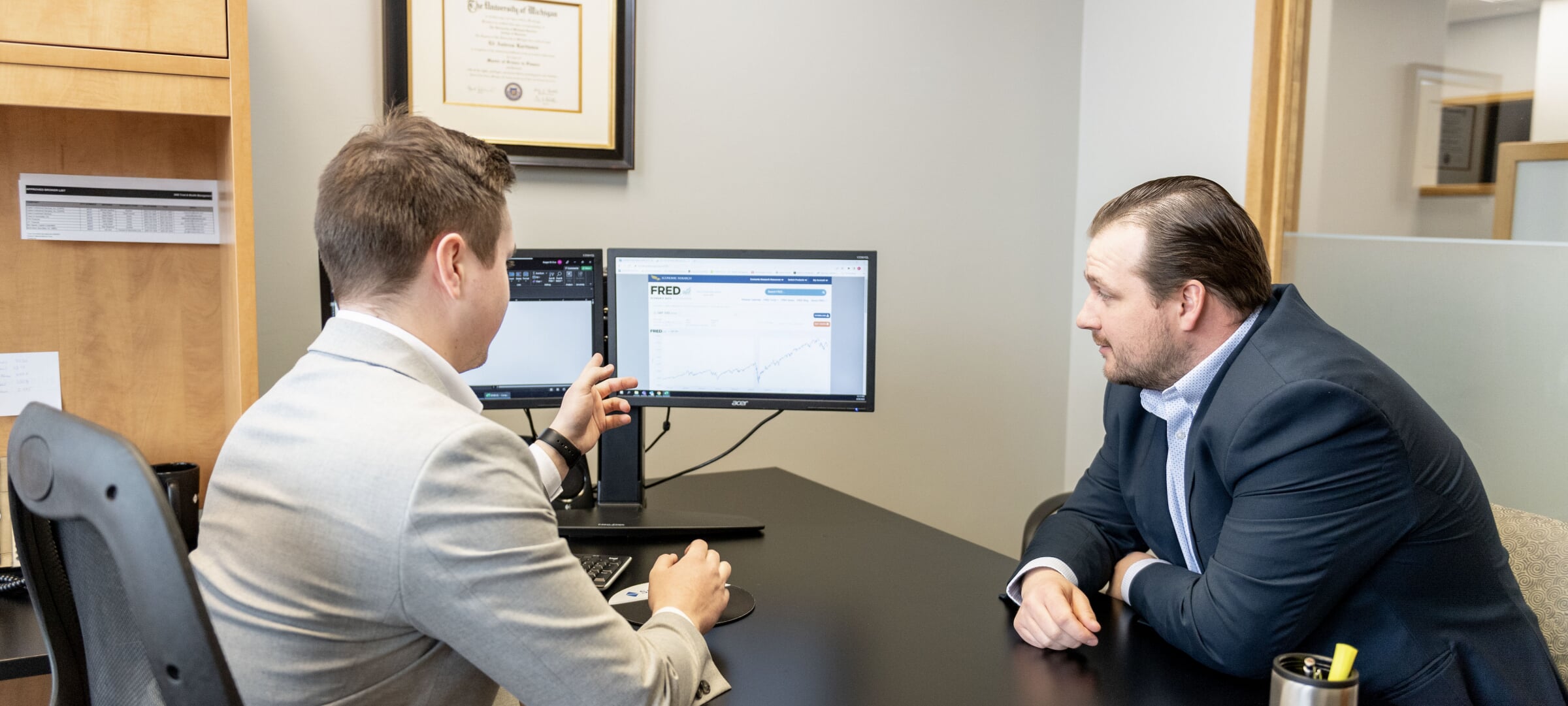 A business analyst confers with a client.