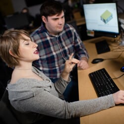 Manager talking about something on a computer with employee