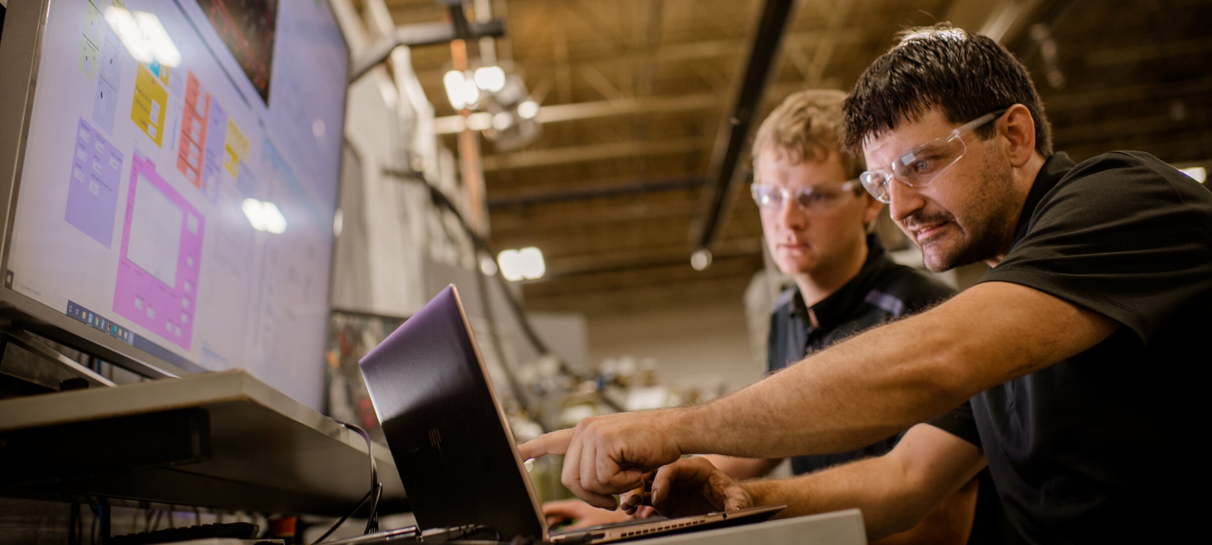 People talking about information on a computer screen