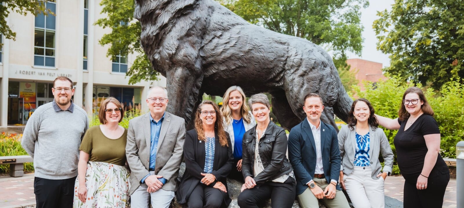 Career Services team in front of Husky statue