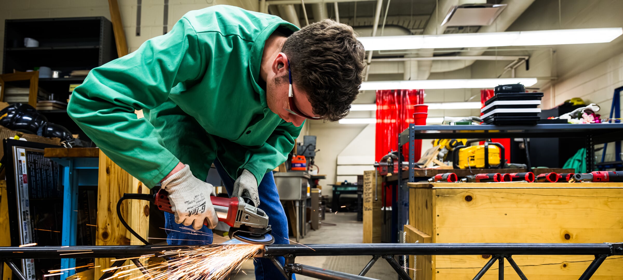 A student using a portable grinder