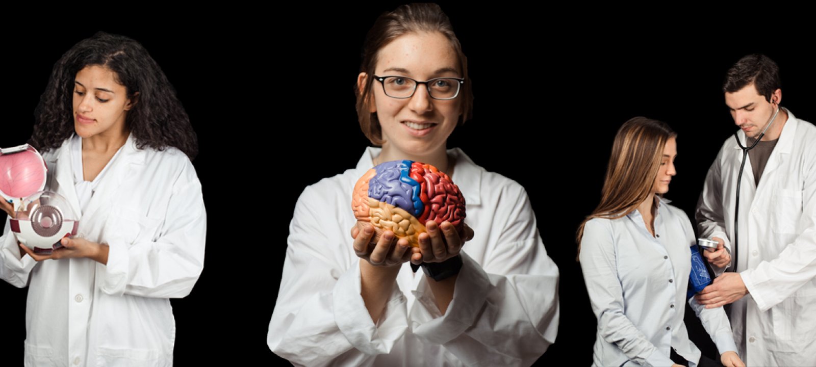 Students in lab coats, some holding models of internal organs