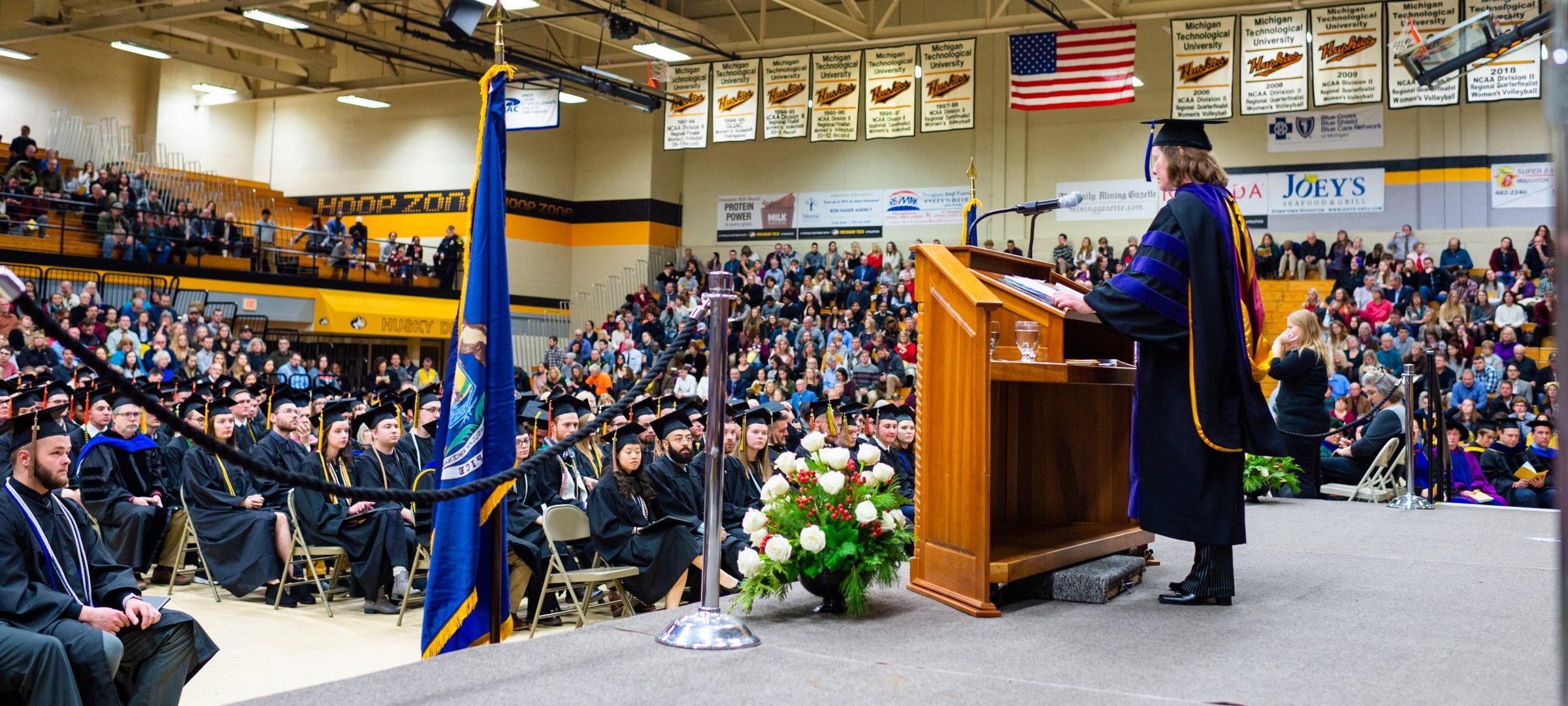 Midyear Commencement with student speaker at the podium