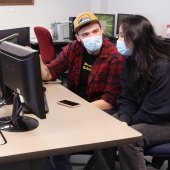 Two students at a computer.