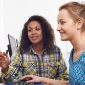 Two women discuss computing