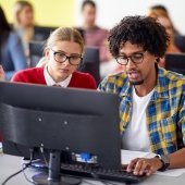 Two students working at a computer.