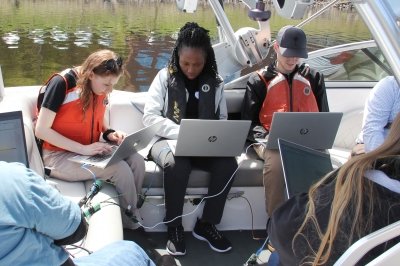 CyberBoat challenge students using computers in a boat