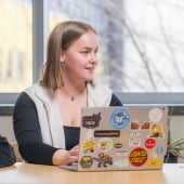 A college of computing student at Michigan Tech with her laptop