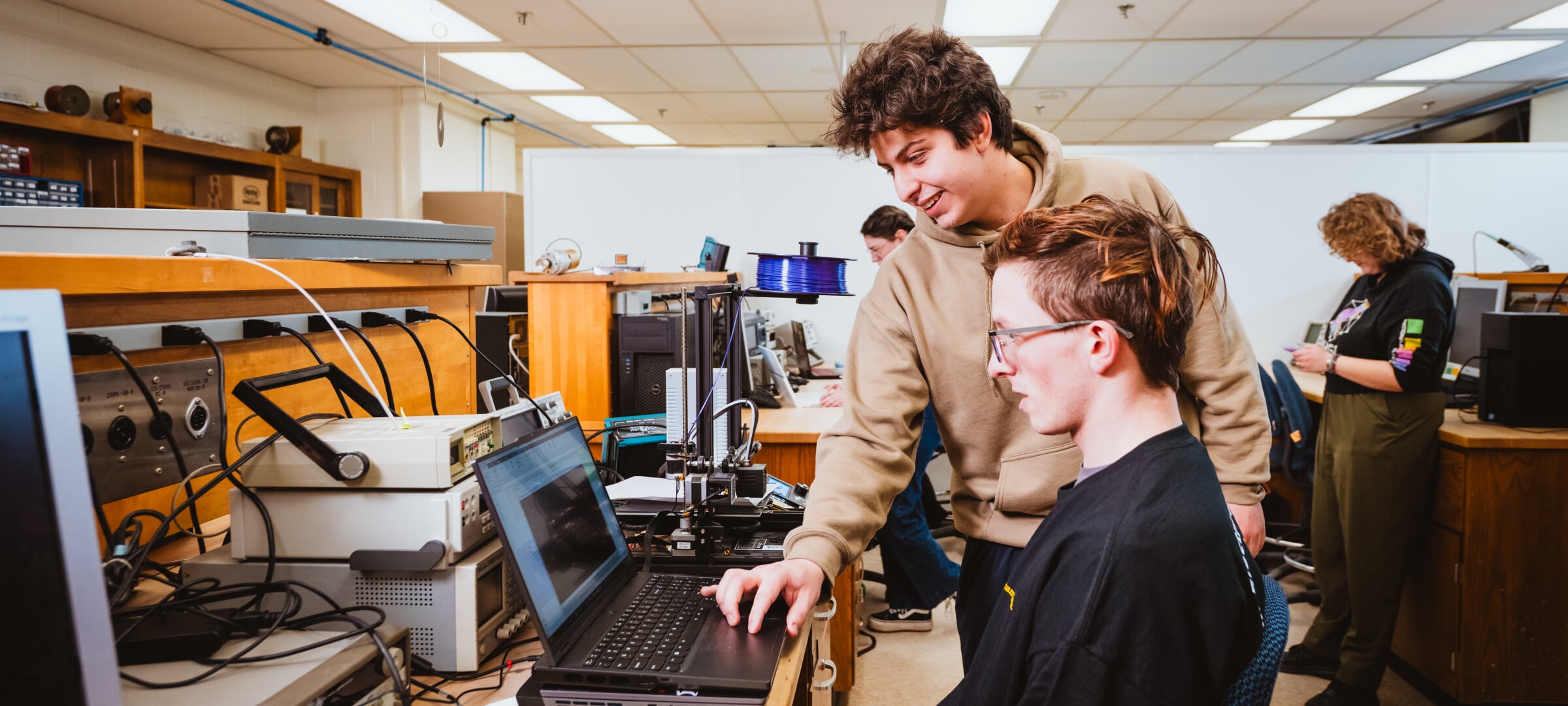 Two students using a laptop