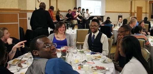 Students and their parents sitting to dinner at an engineering function.