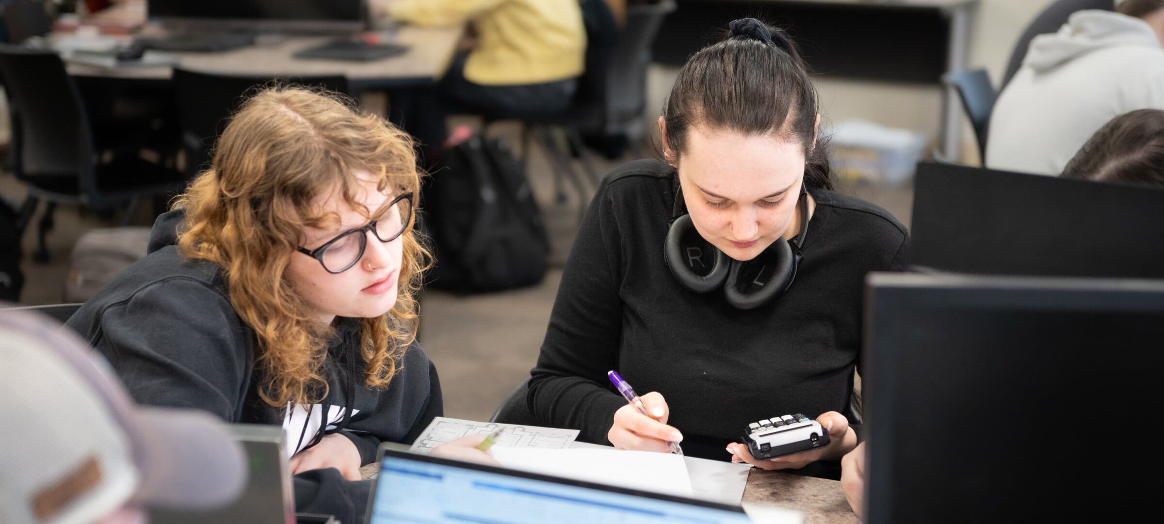 Two students working on an engineering problem