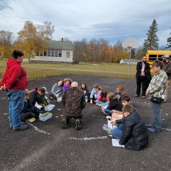 Outreach program working with students outdoors