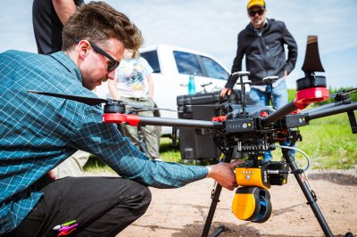 Researcher adjusting a drone.