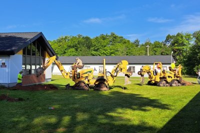 Two mini excavators digging for the new patio.