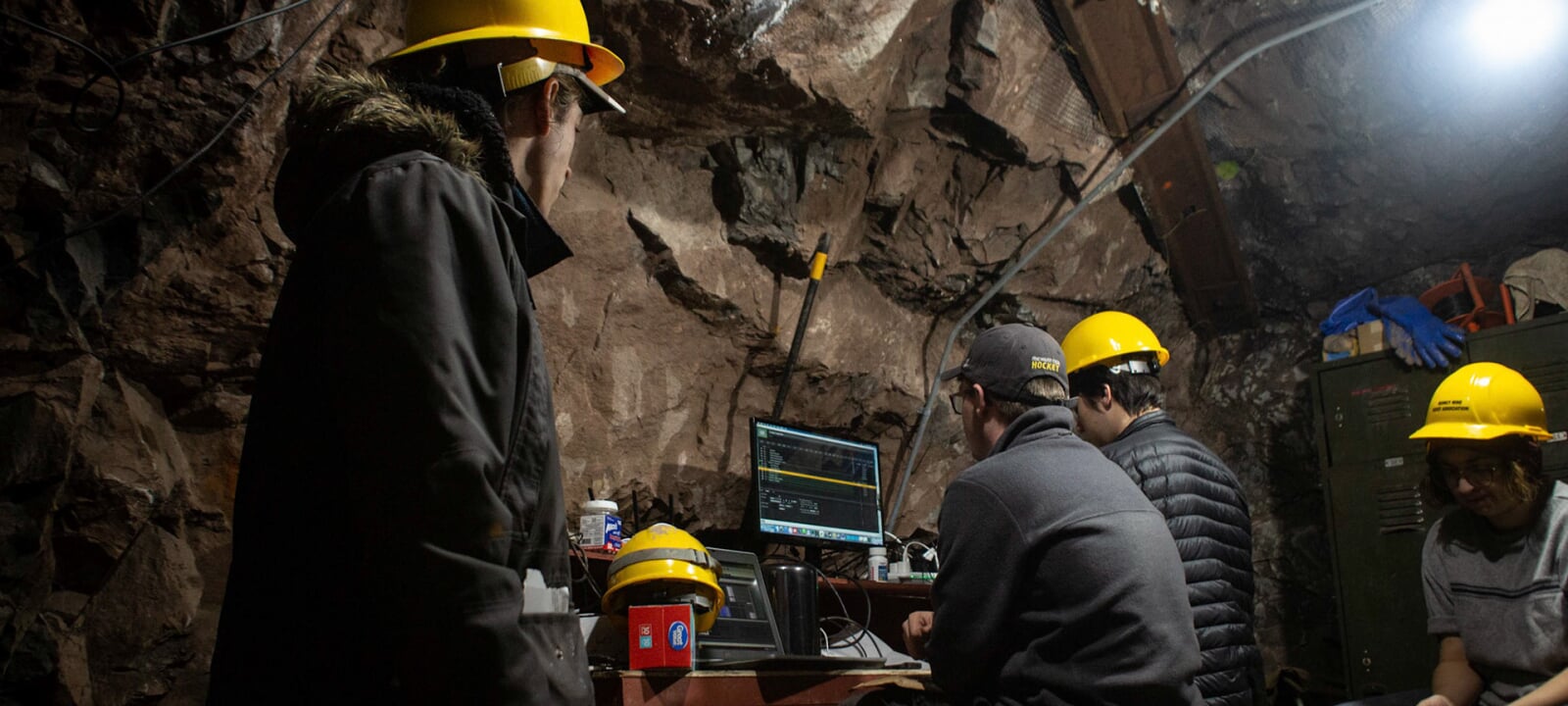 Students underground on a computer