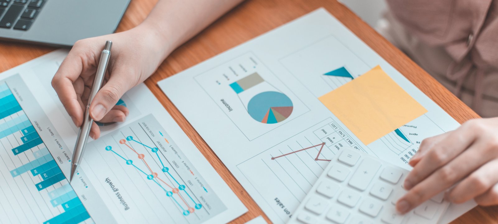 A person analyzing some printouts of data visualizations.