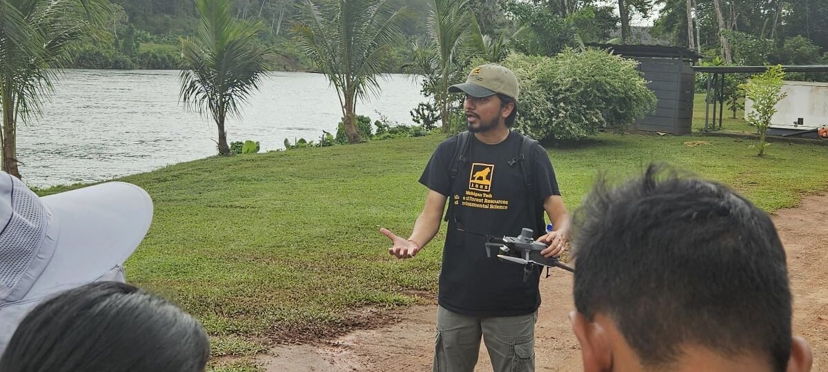 Dr. Parth Bhatt holding a drone while he is conducting a workshop in Suriname