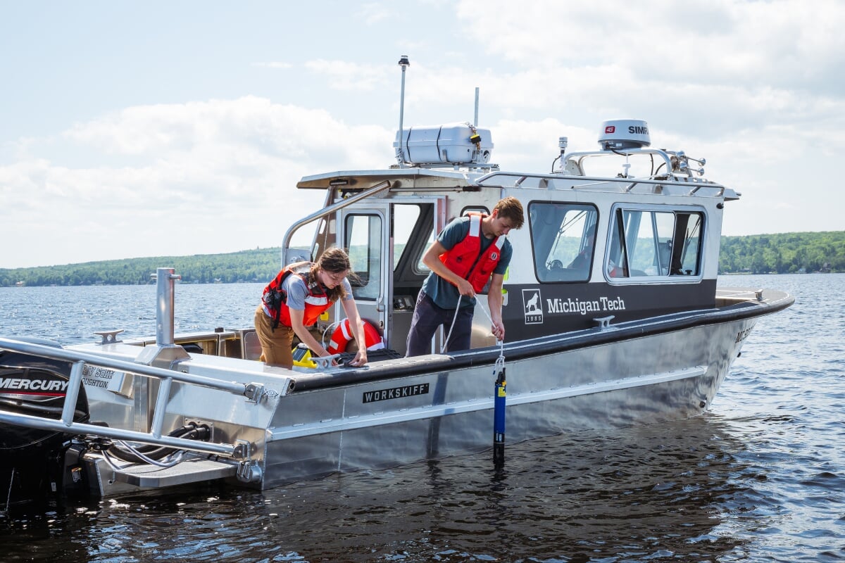 Lake Superior is all around you here in the Keweenaw Peninsula. Students doing research from a boat in the water.