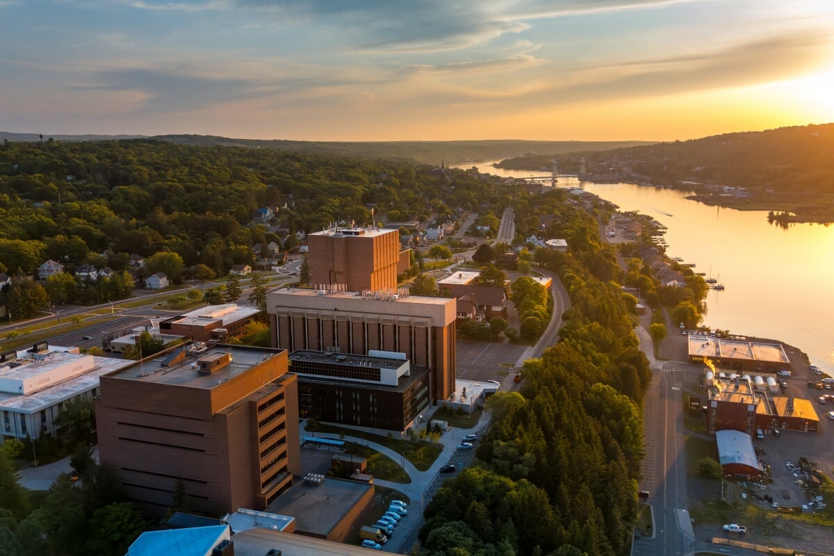 Our campus in Houghton is the perfect blend of technology and natural beauty. Aerial view of the Michigan Tech campus during a sunset.