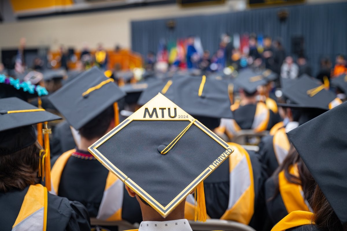 Students at commencement in the wood gym