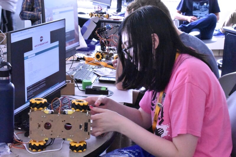 SYP student working on a small robot
