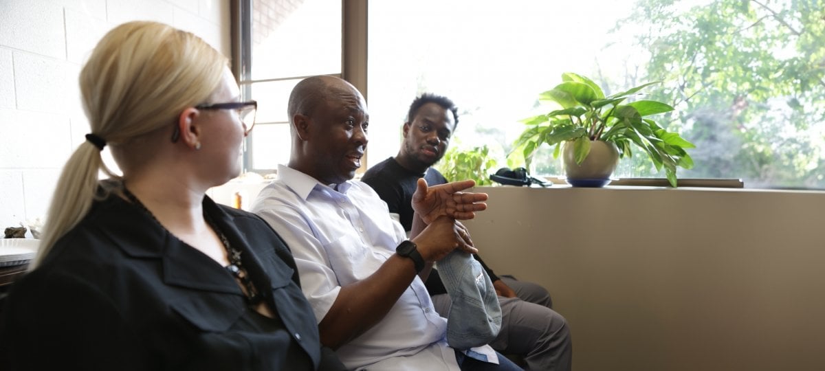 Kendall Belopavlovich, James Akinola, and Eugene Agyei (RTC PhD) engage in discussion with a guest lecturer.