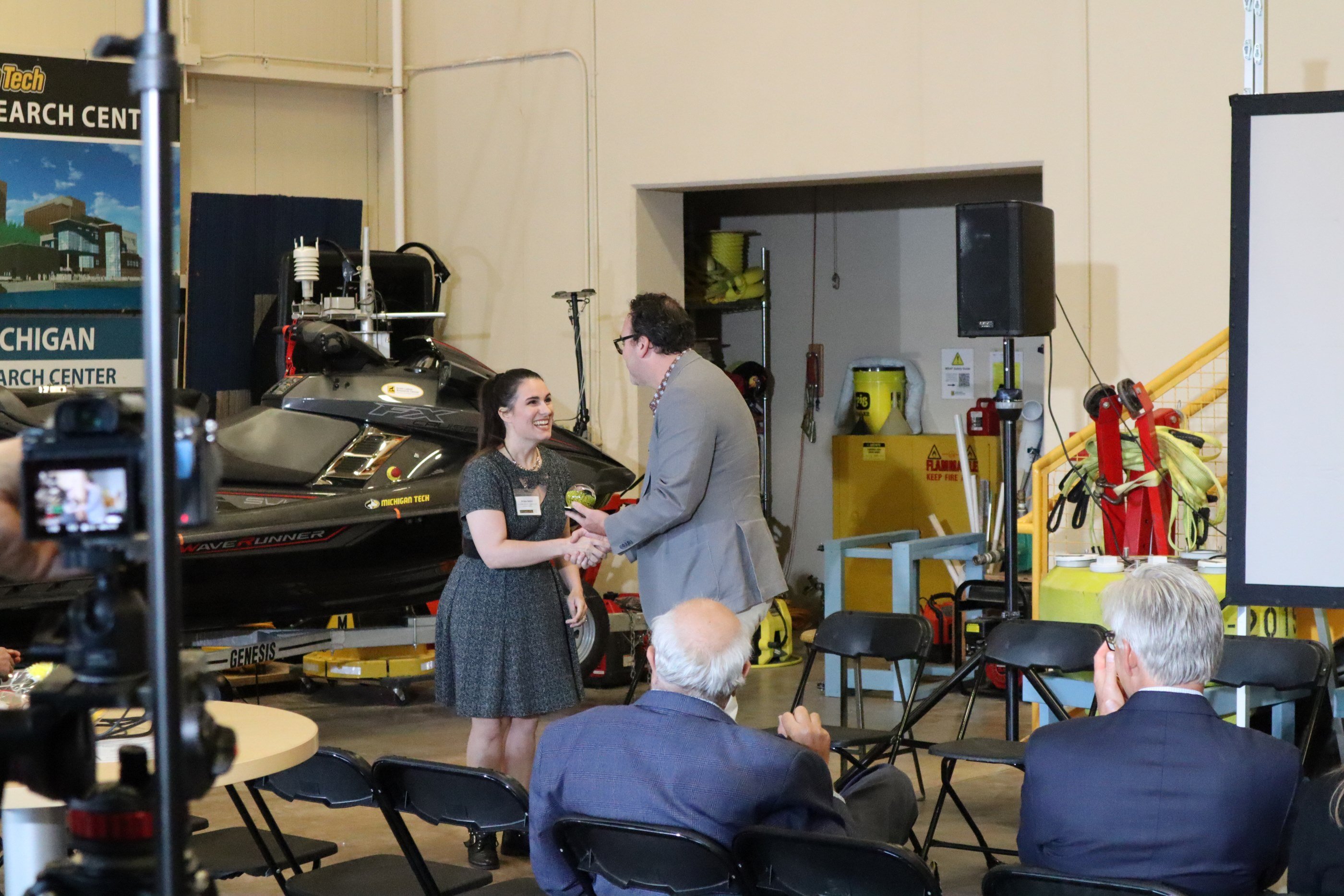 Briana Bettin recieving her ICC Achievement Award. Briana Bettin shaking hands with the presenter.