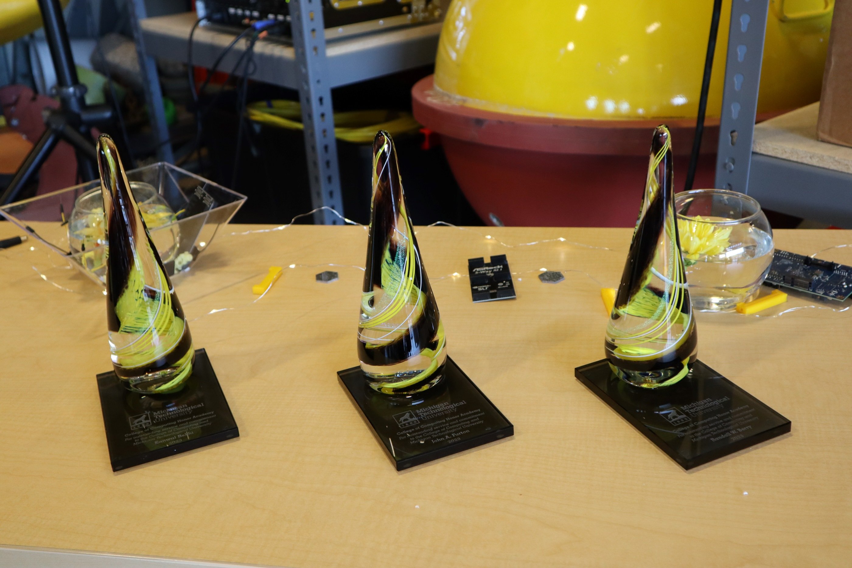 The College of Computing Honor Academy Awards, given to Kanwal Rehki, John Furton, and Randy Berry. Three awards on a table.
