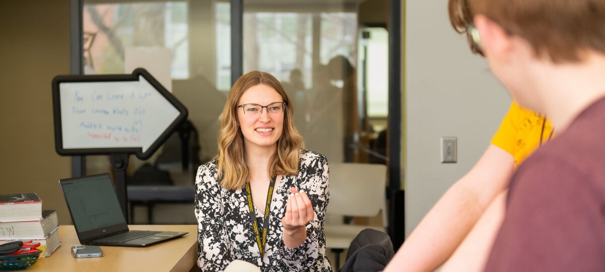 Coach helping a student in the Math Learning Center