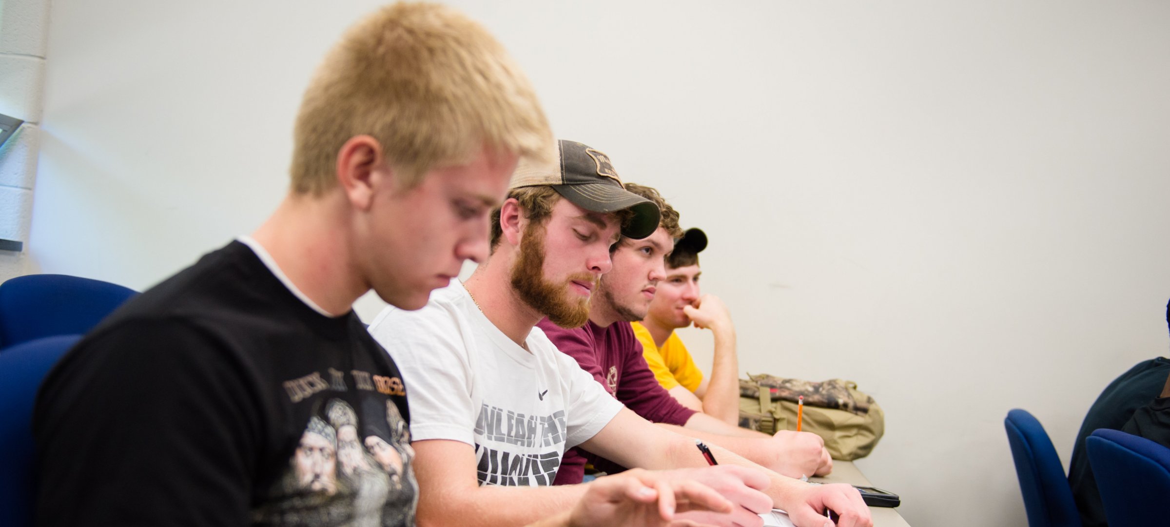 Students taking notes in a Mathematics course